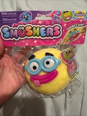 Smushers - Yellow Squishy Emoji Toy with Blue Glasses and Pink Tongue 💖